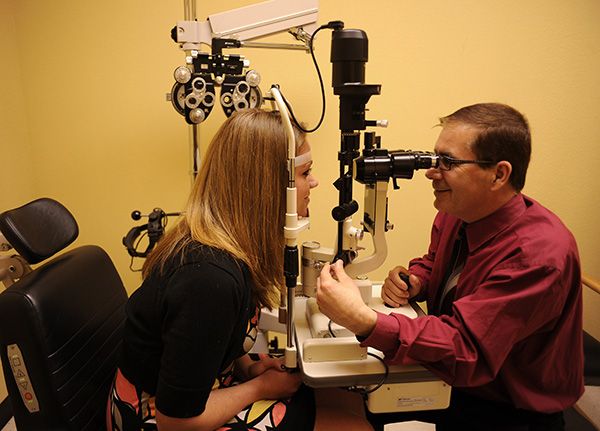Dr. Mansur Nurdel examines a patient's eyes at one of his offices.